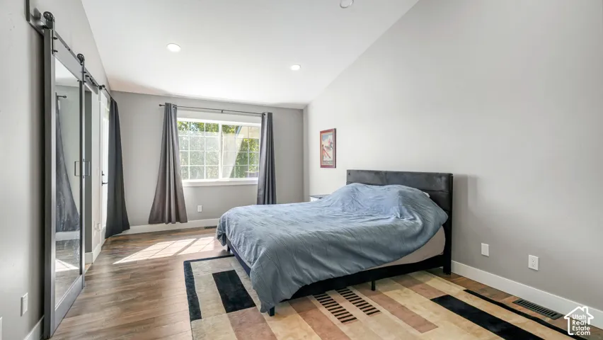 Master has vaulted ceiling with recessed lighting