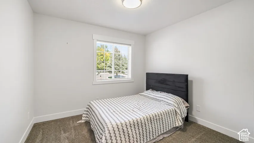 Bright interior with neutral wall colors, carpet flooring, and a window with white trim