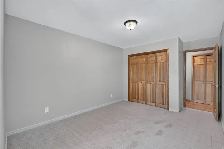 Neutral-toned wall paint and textured carpeting define this interior space