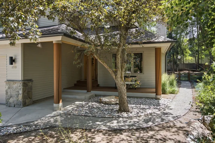 Exterior facade featuring light-toned siding and a covered entry