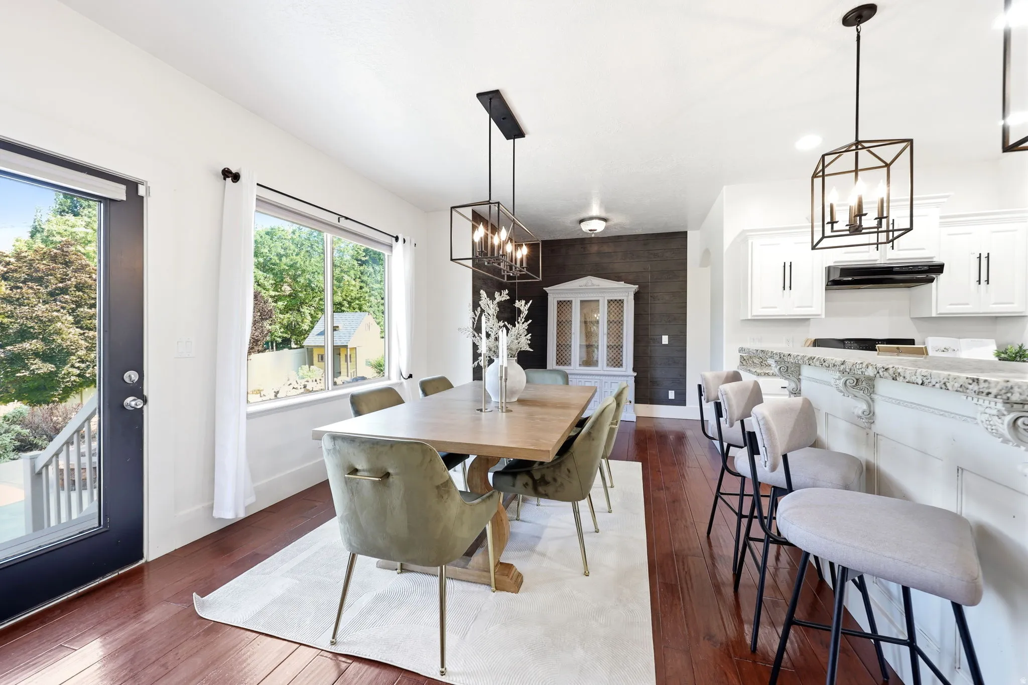 Open-concept dining area featuring a wood-finish floor and a large window