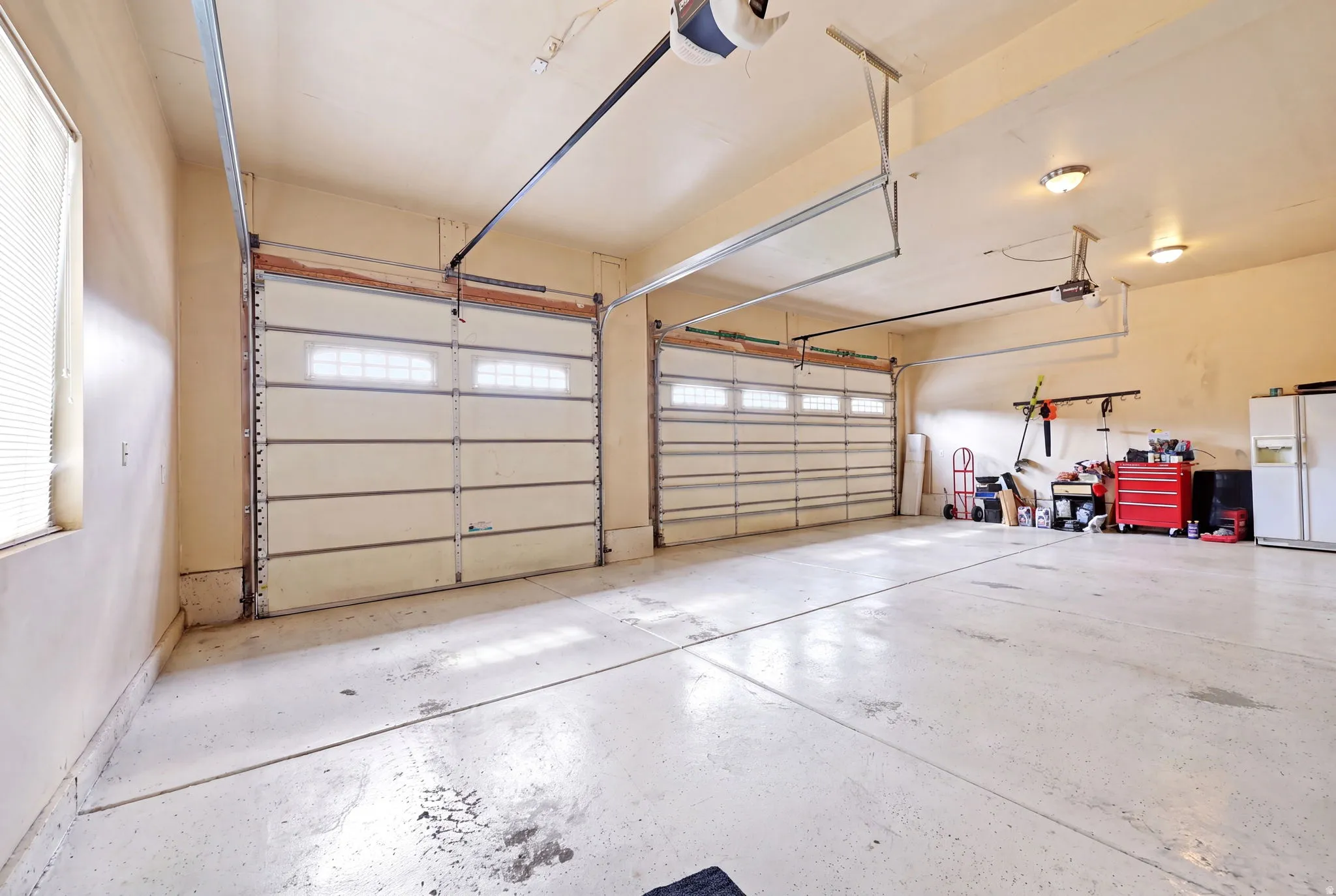 Two garage doors with upper window panels