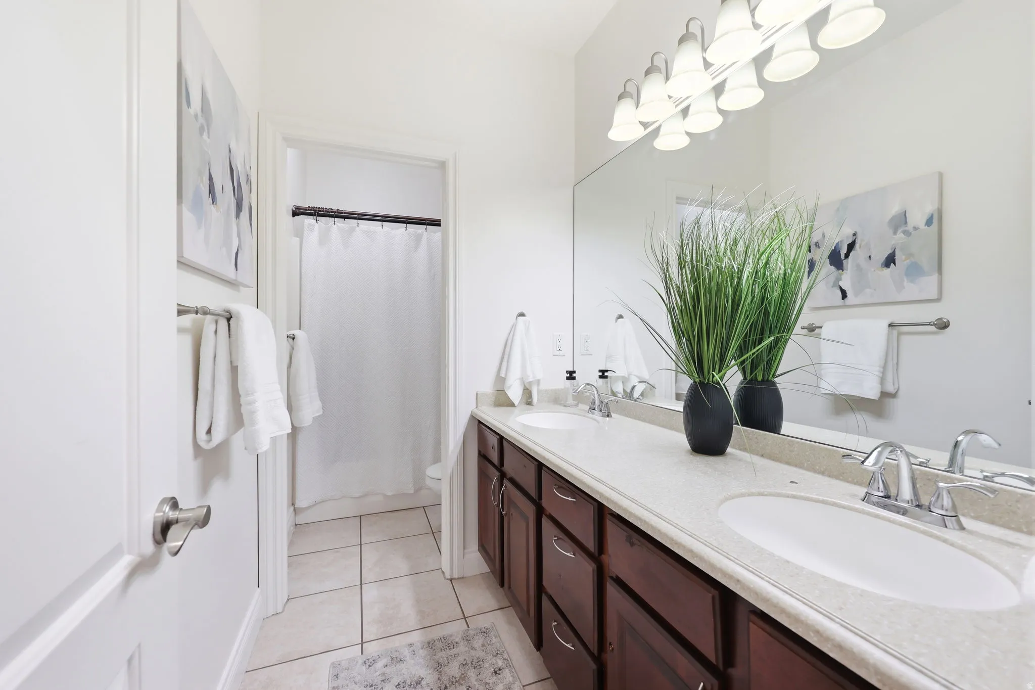 Dual vanity with undermount sinks and chrome fixtures, set in a light-toned countertop