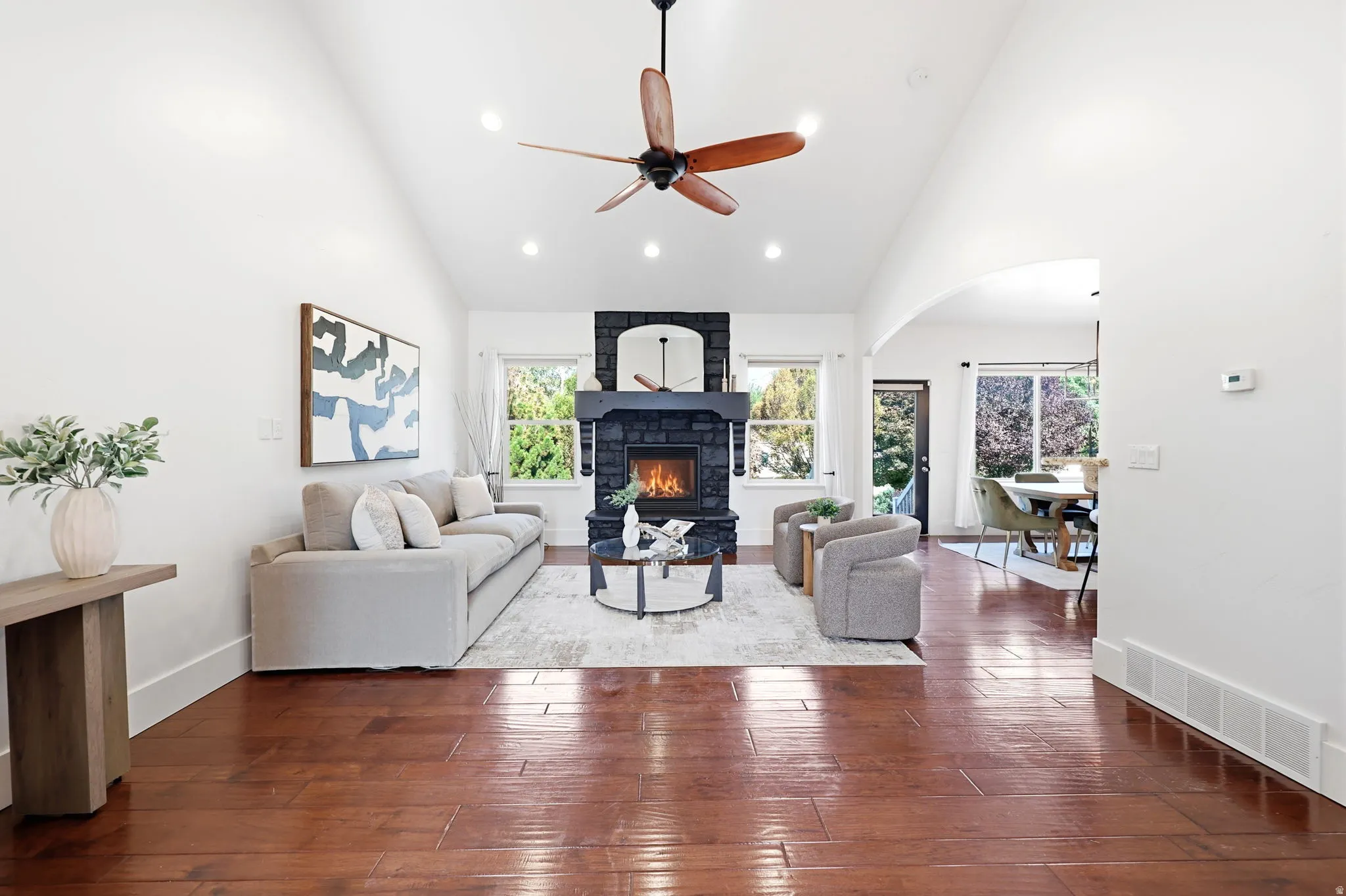 Vaulted ceilings with recessed lighting and a wood-bladed ceiling fan