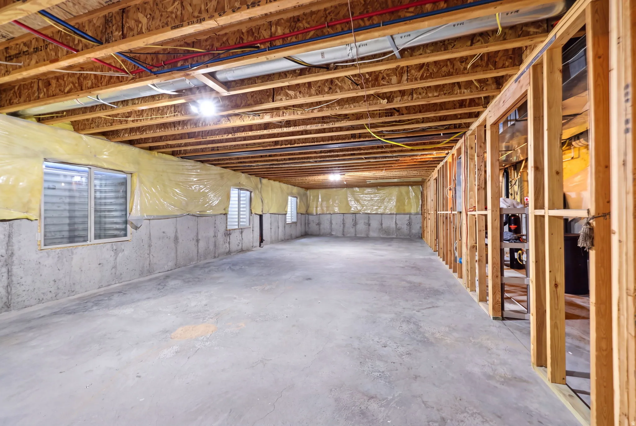 Unfinished basement offering extensive open space with concrete flooring