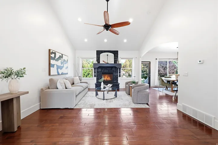 Vaulted ceilings with recessed lighting and a wood-bladed ceiling fan