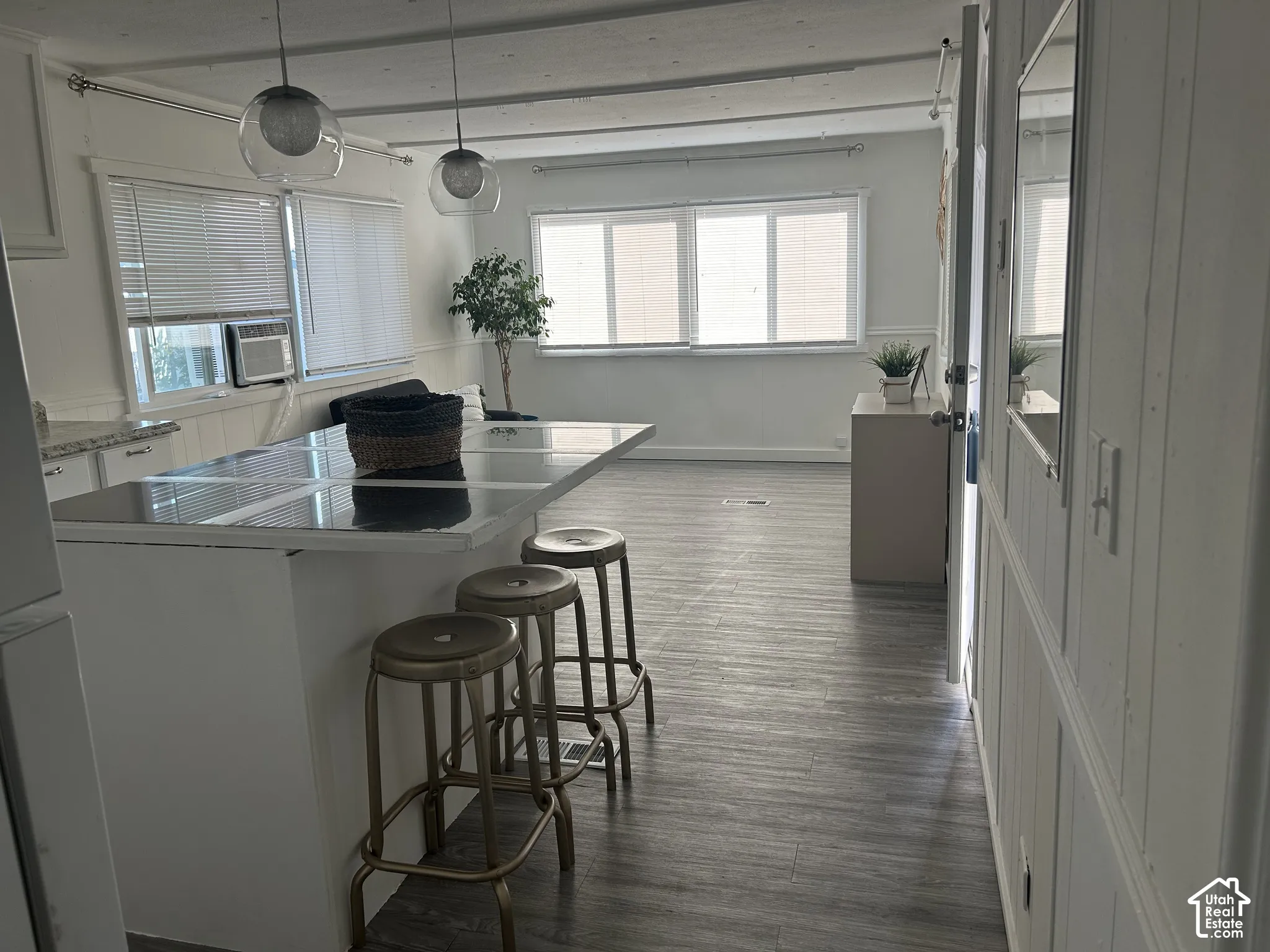 Open-concept living area featuring wood-finish LVP flooring and ample natural light from multiple windows