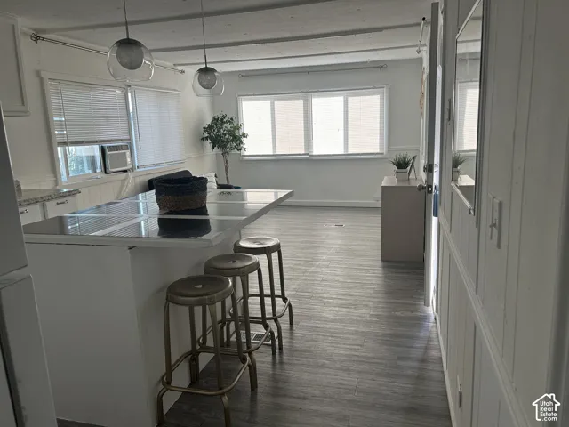 Open-concept living area featuring wood-finish LVP flooring and ample natural light from multiple windows