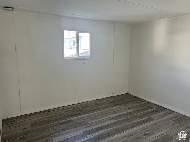 Interior space featuring wood-finish LVP flooring, white walls, white baseboards