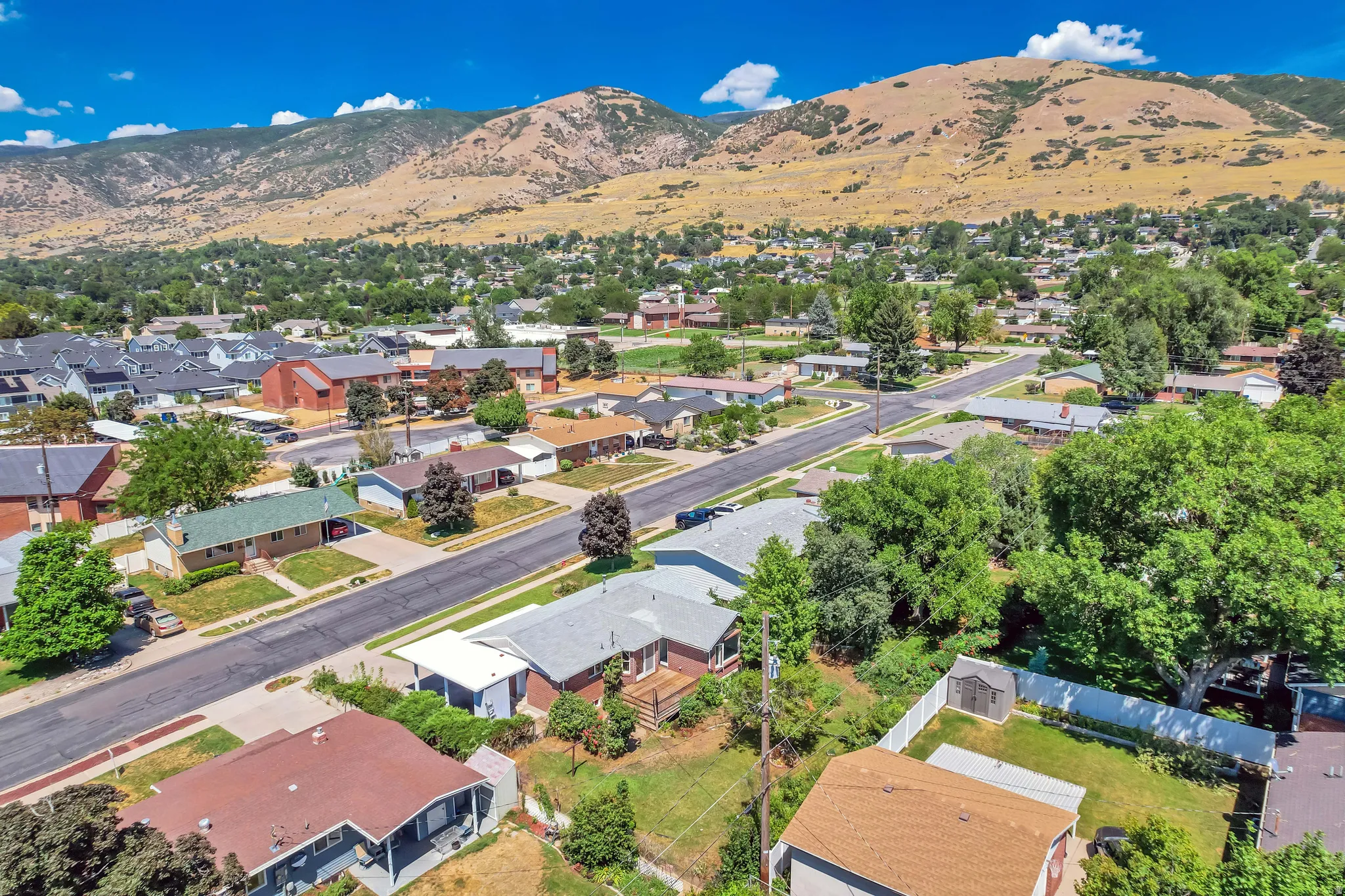 Aerial perspective showcasing a residential neighborhood with a mountainous backdrop