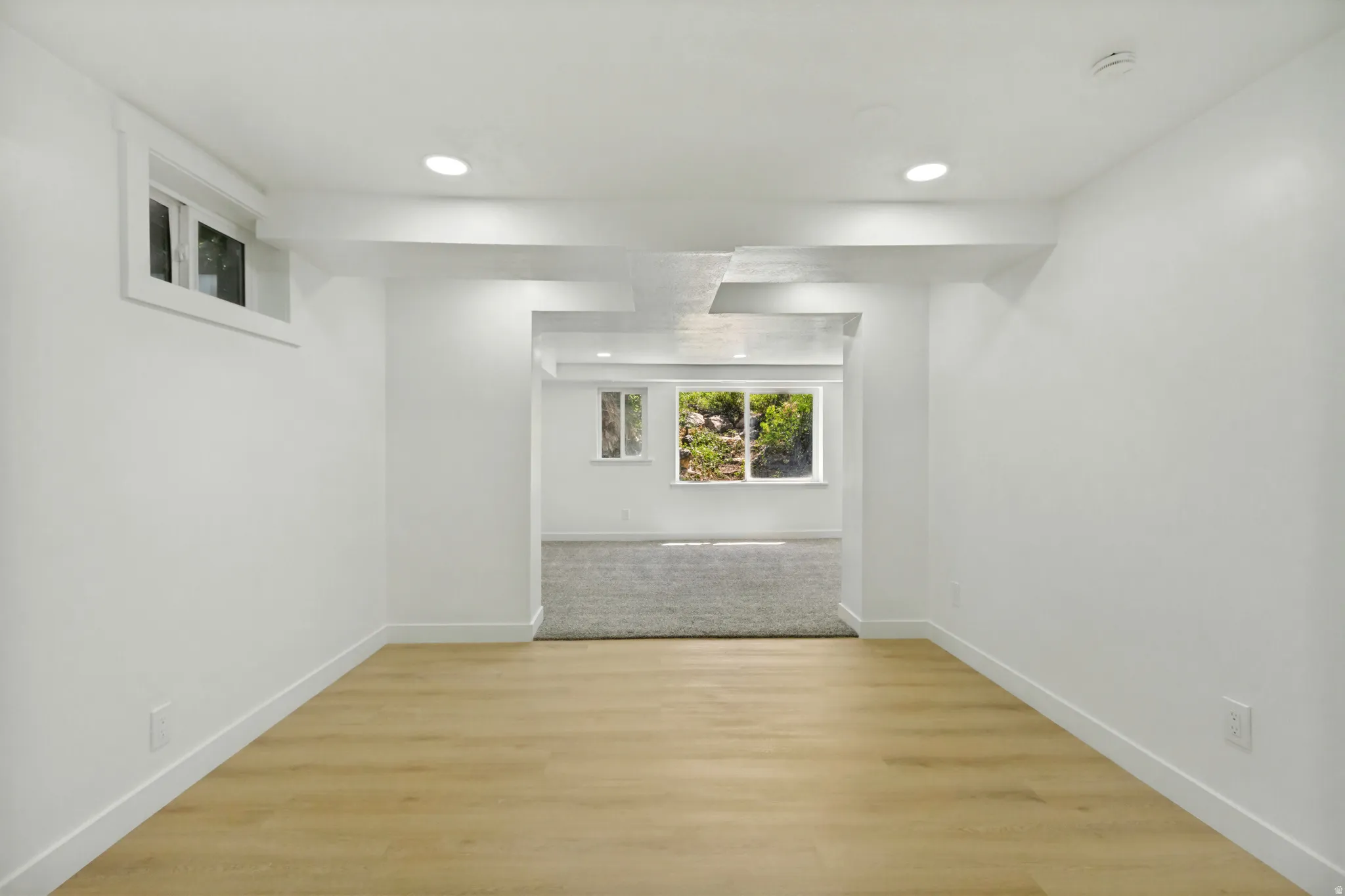 Bright interior space featuring light wood-finish flooring, recessed lighting, and crisp white walls
