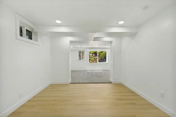 Bright interior space featuring light wood-finish flooring, recessed lighting, and crisp white walls