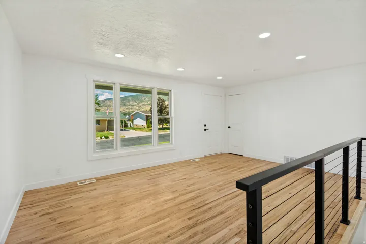 Bright living area with wood-finish flooring and recessed lighting