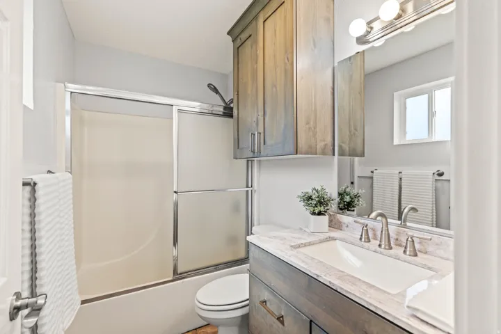 Bathroom featuring a vanity with a light-toned countertop, an integrated sink, and a brushed nickel faucet
