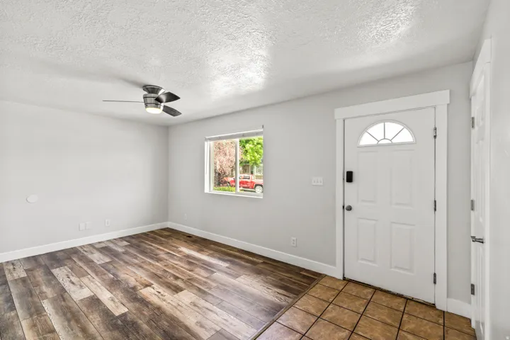 Entry area featuring a white paneled door with an arched glass insert and a digital lock