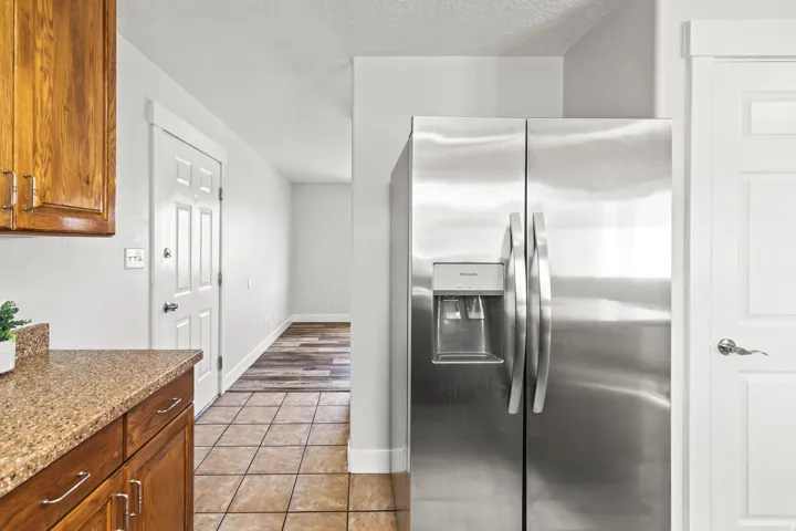 Stainless steel side-by-side refrigerator with exterior ice and water dispenser