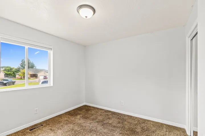 Interior room featuring light-colored walls and brown carpeting