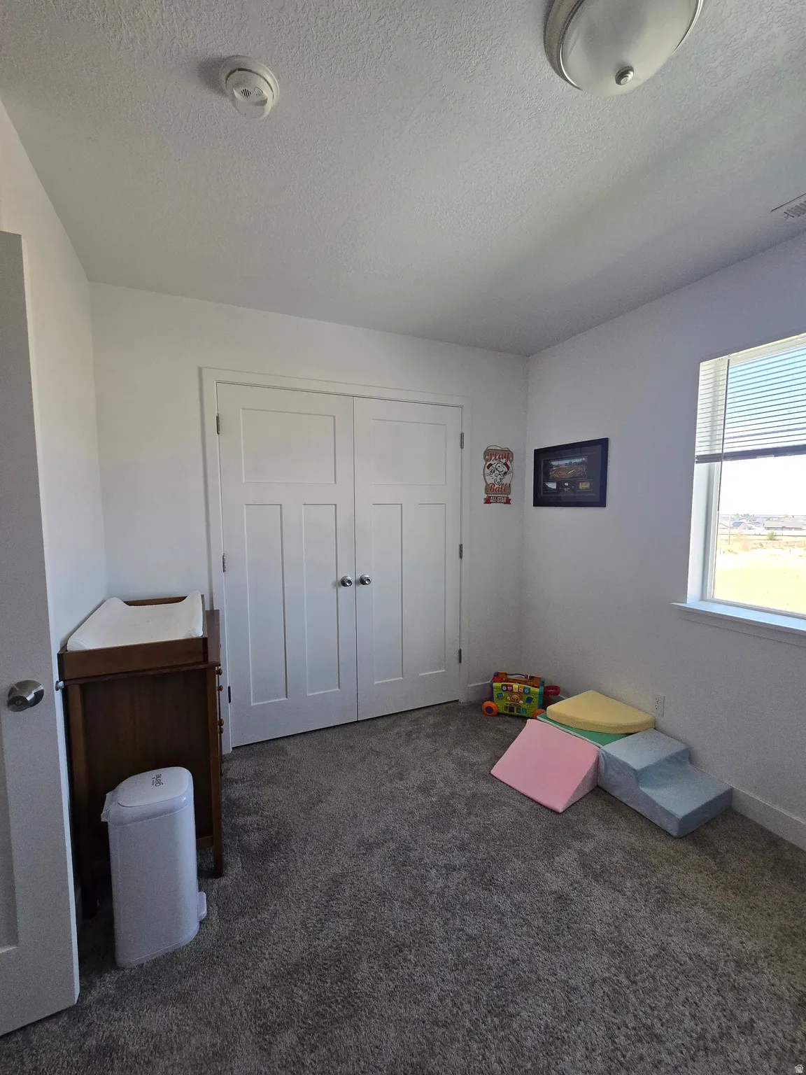 Neutral gray carpet flooring complements white walls and trim