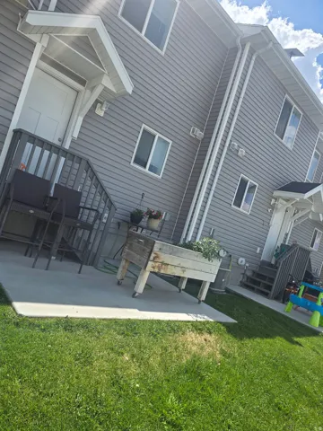Grey horizontal siding with white trim accents and multiple windows