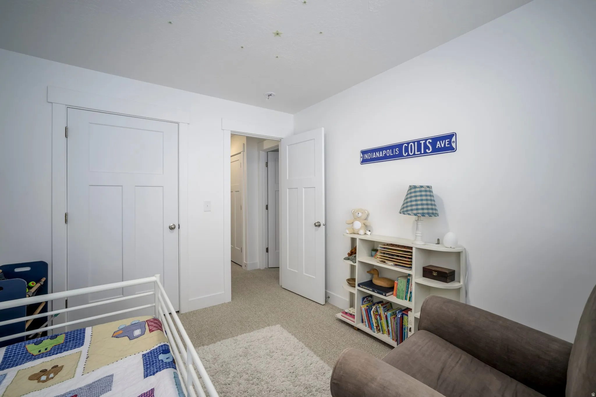 Carpeted room featuring white walls, white trim, and two white panel doors