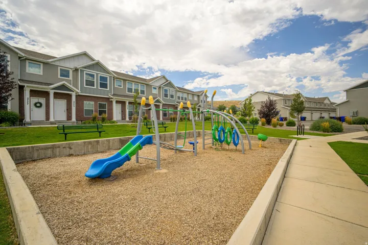 Central playground area with rubber mulch surfacing and a blue and green slide