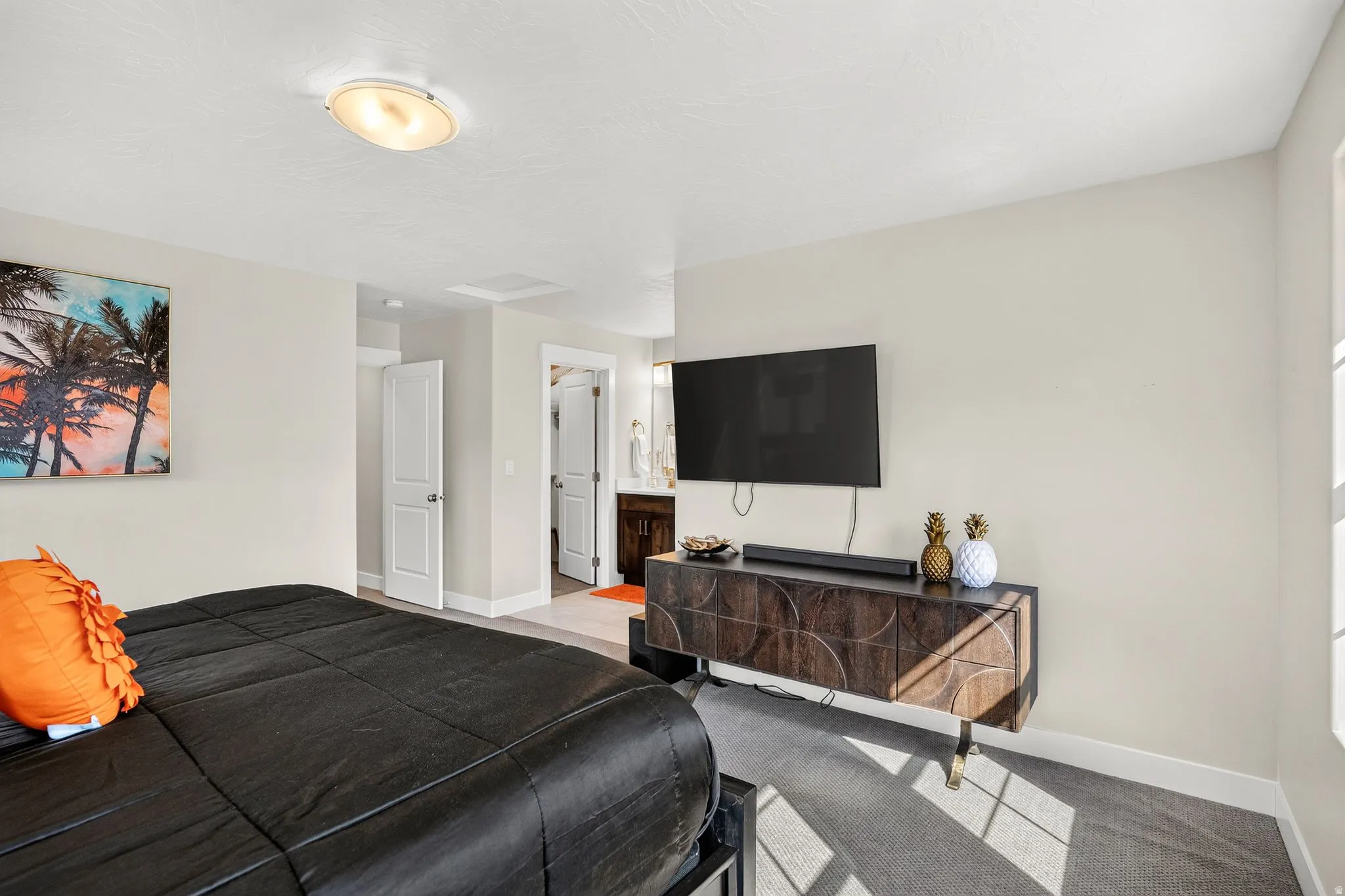 Bright bedroom with neutral wall tones and a ceiling-mounted light fixture