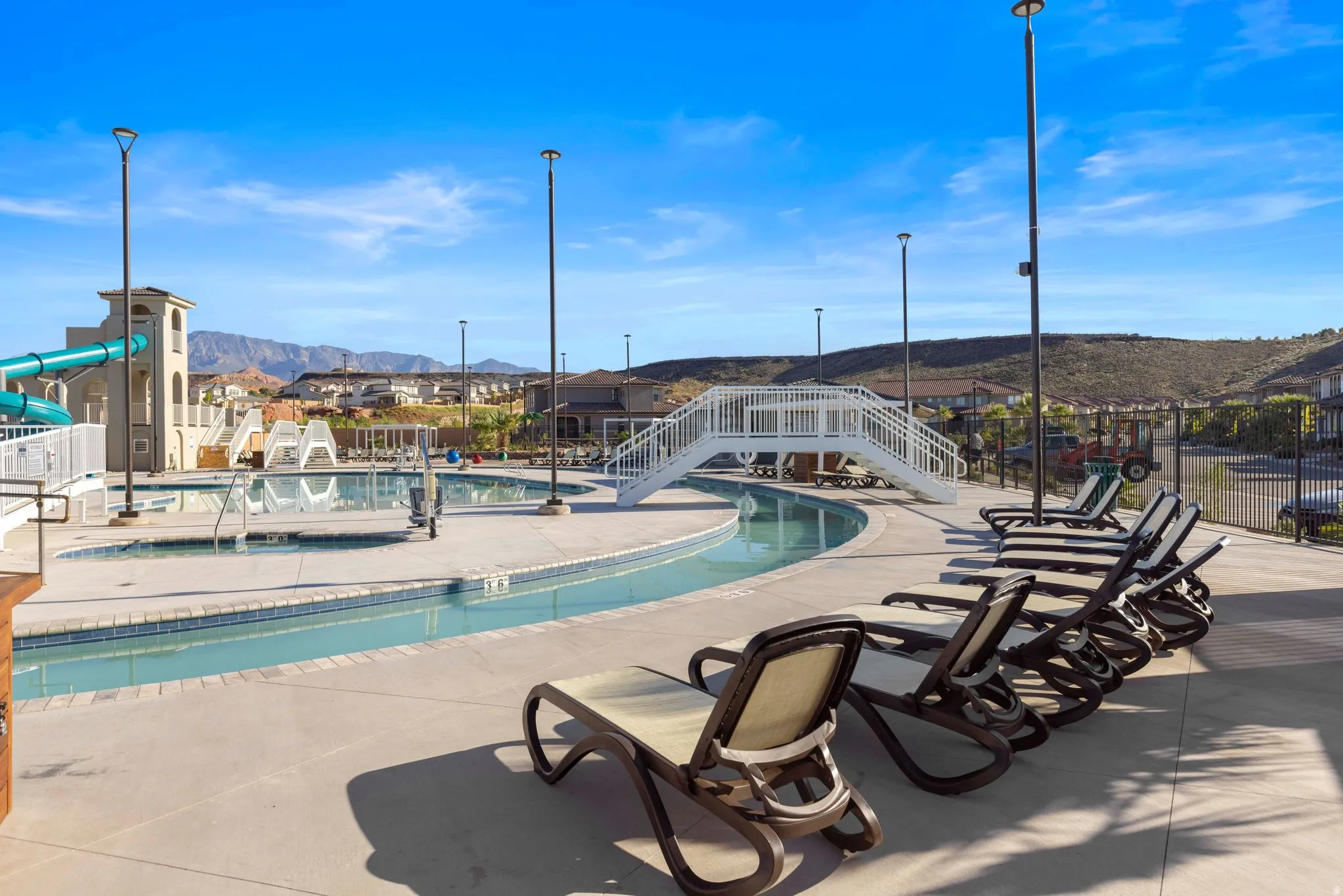 Resort-style pool area featuring a lazy river, water slides, and multiple swimming pools