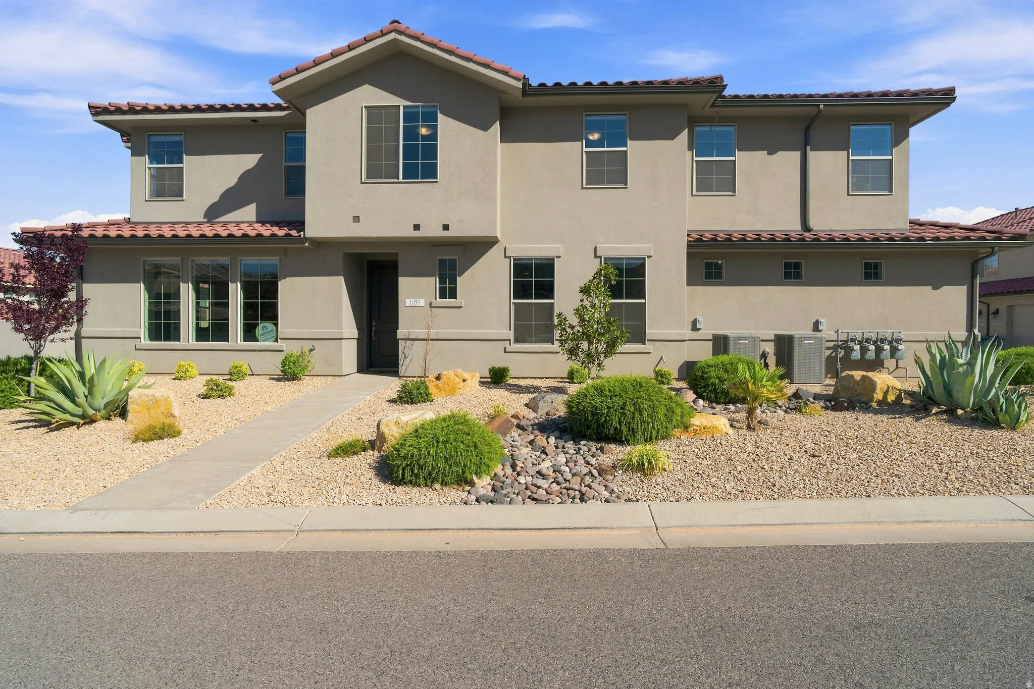 Stucco exterior with a tiled roofline