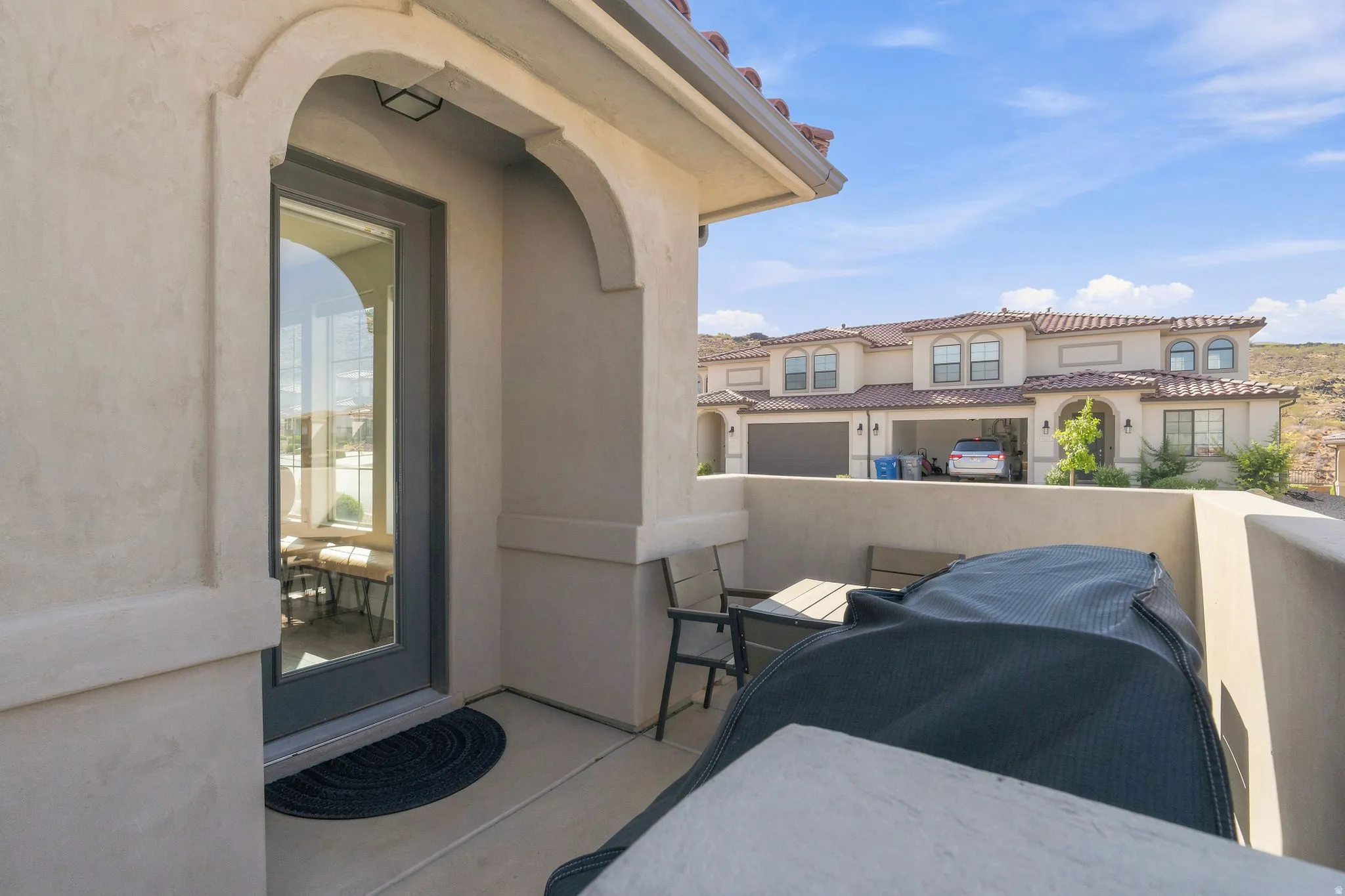 Covered patio with stucco finish and a glass-paneled door