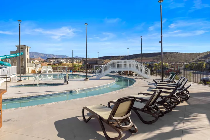 Resort-style pool area featuring a lazy river, water slides, and multiple swimming pools