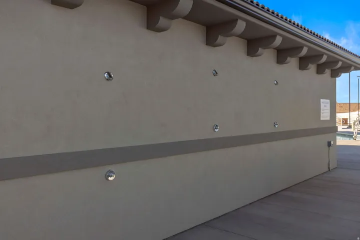 Stucco exterior with a decorative corbel cornice and tile roof