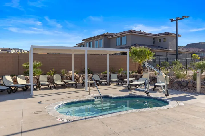 Outdoor spa with a tile surround and a pool lift