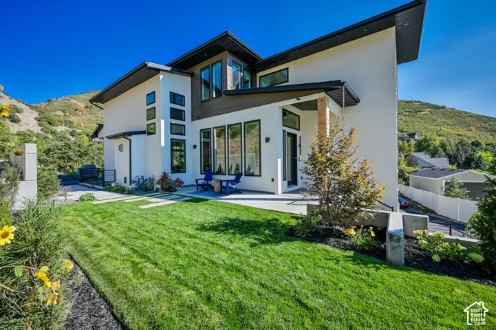 Modern exterior featuring white stucco and wood-finish siding
