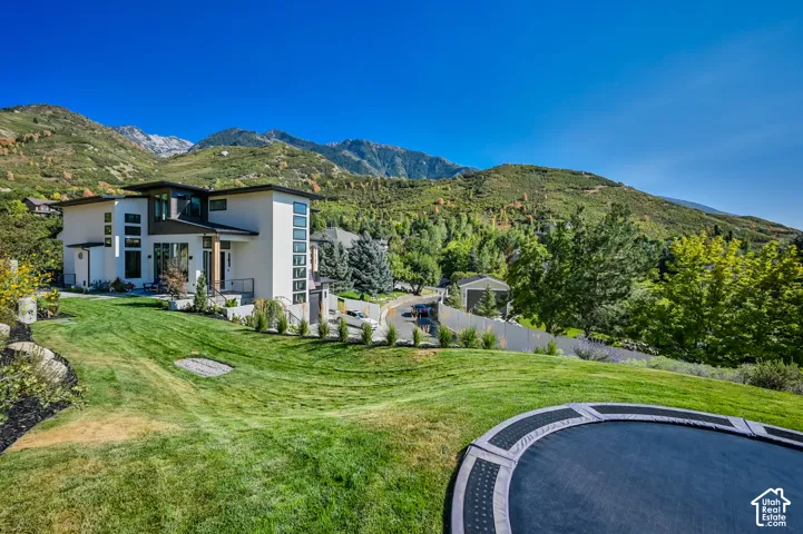 Contemporary multi-level residence featuring a flat roofline, extensive window placement, and a light-toned exterior finish