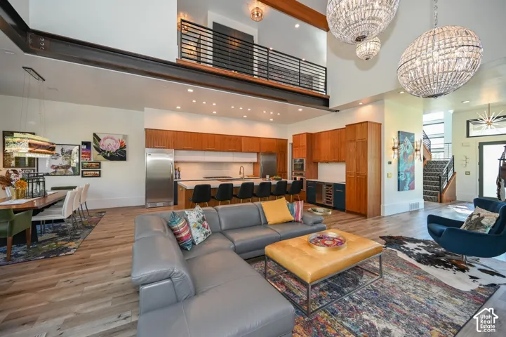 Loft-style architecture with an open-concept layout, wood-finish flooring, and a gourmet kitchen featuring stainless steel appliances