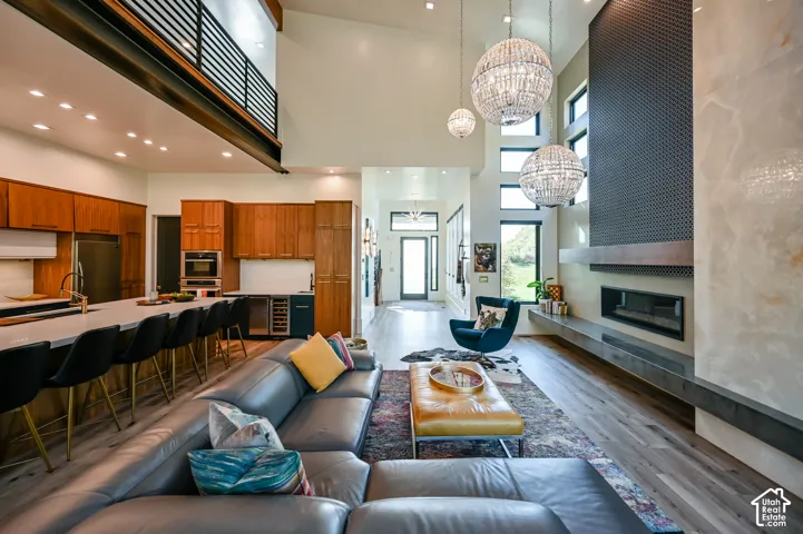 Expansive living area featuring soaring ceilings and wood-finish flooring