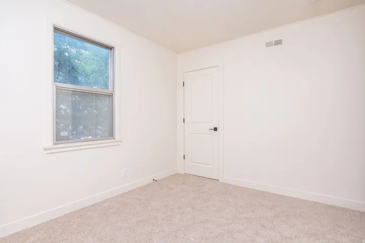 Neutral color palette with light-toned carpeting and white walls
