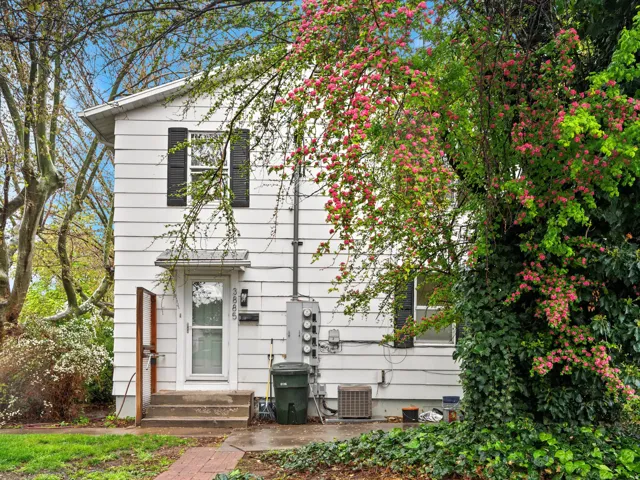 White siding exterior with black window shutters