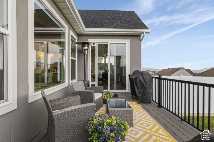 Exterior deck featuring a black metal railing and a sliding glass door
