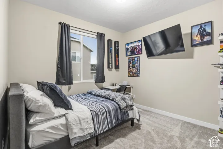 Room featuring light beige walls and grey carpet flooring