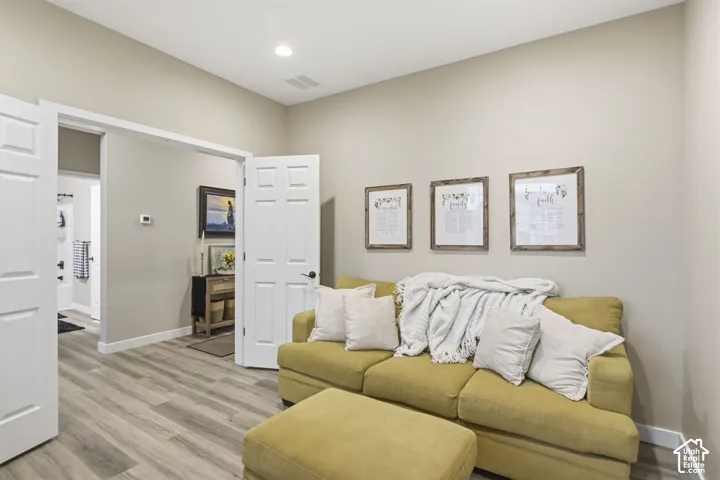 Open concept room featuring light wood-finish flooring and neutral wall tones