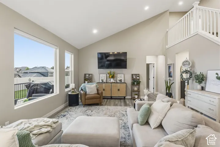Spacious living area featuring vaulted ceilings and recessed lighting
