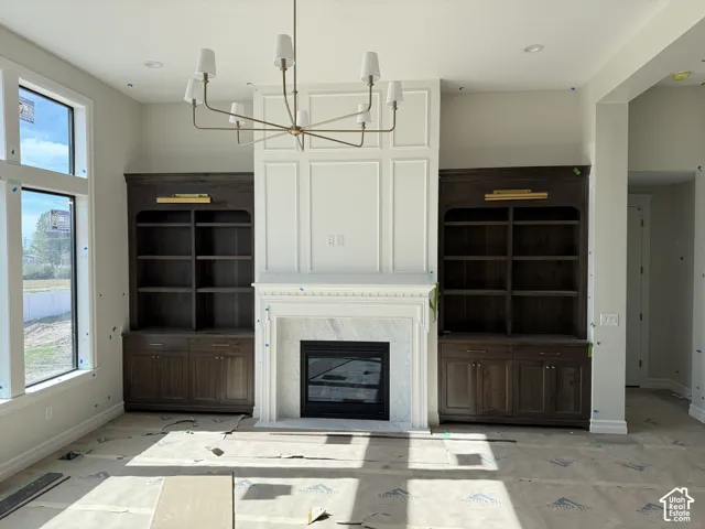 Central fireplace with a white mantel, flanked by built-in dark wood cabinetry