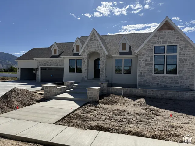 Stone and stucco exterior with multiple gables