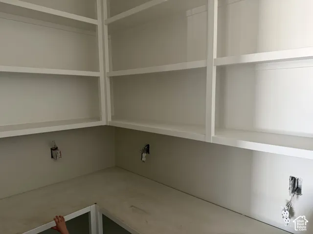Built-in shelving with multiple storage levels and light-toned finishes