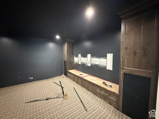 Built-in cabinetry with wood-finish doors and brass hardware