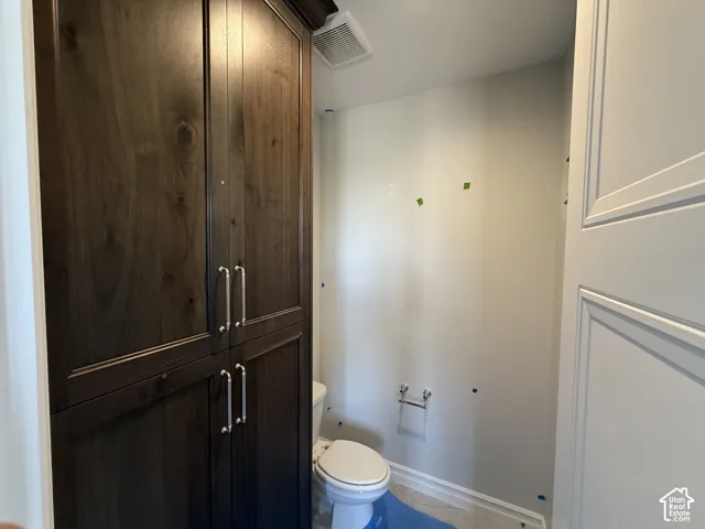 Floor-to-ceiling dark wood cabinetry with chrome hardware