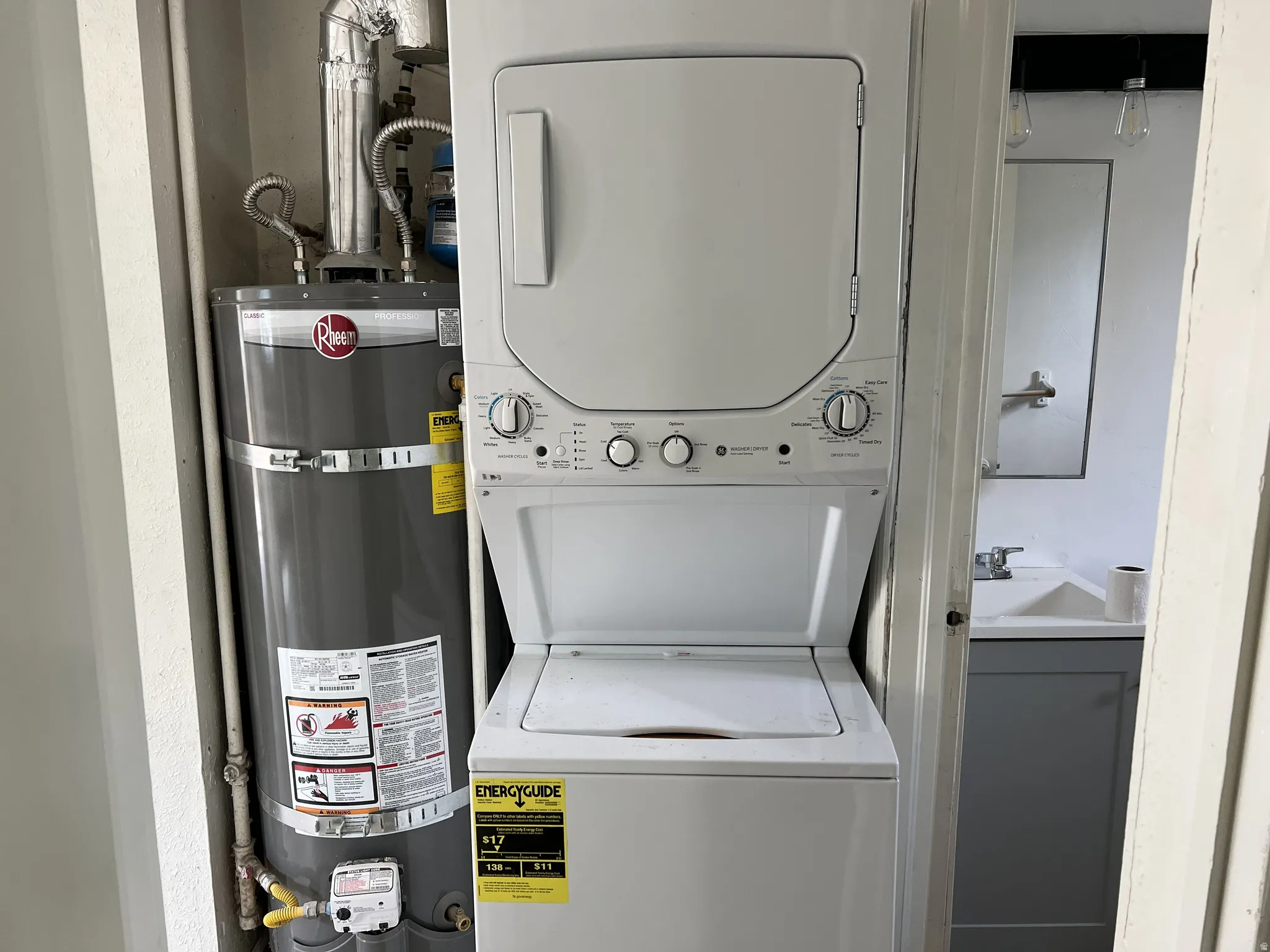 Dedicated laundry closet featuring a white stacked washer and dryer unit