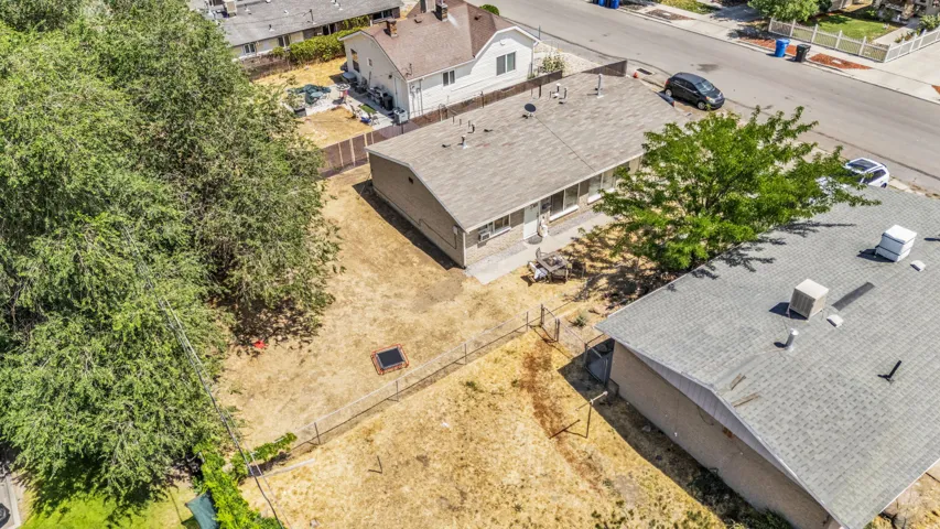 Expansive property grounds featuring a spacious backyard, mature trees, and fencing
