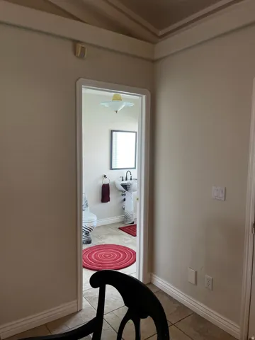Pedestal sink with wall-mounted mirror, ceramic tile flooring, and a flush mount ceiling light fixture